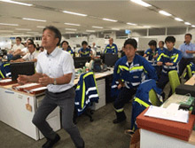 Scene of squat exercises,part of a health-enhancement physical training program being conducted before the start of the day
